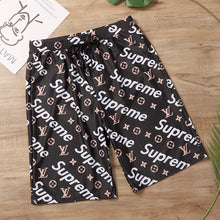 Load image into Gallery viewer, IN STOCK LV x S Black, Gold, &amp; White Swim Trunks
